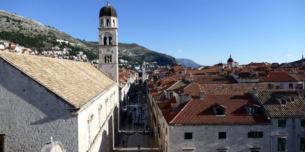 Stradun and the Franciscan monastery bell tower seen from Dubrovnik's city walls, a car-free street