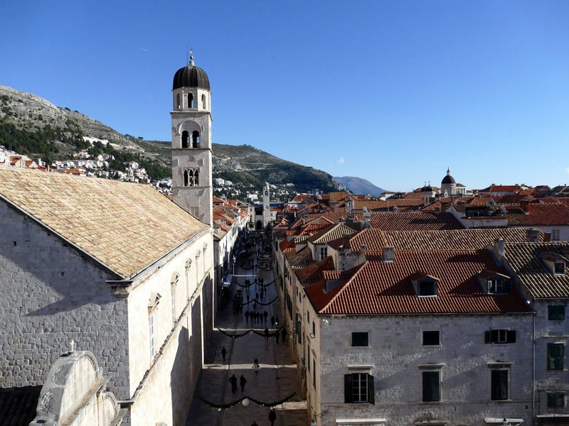 Stradun and the Franciscan monastery bell tower seen from Dubrovnik's city walls, a car-free street